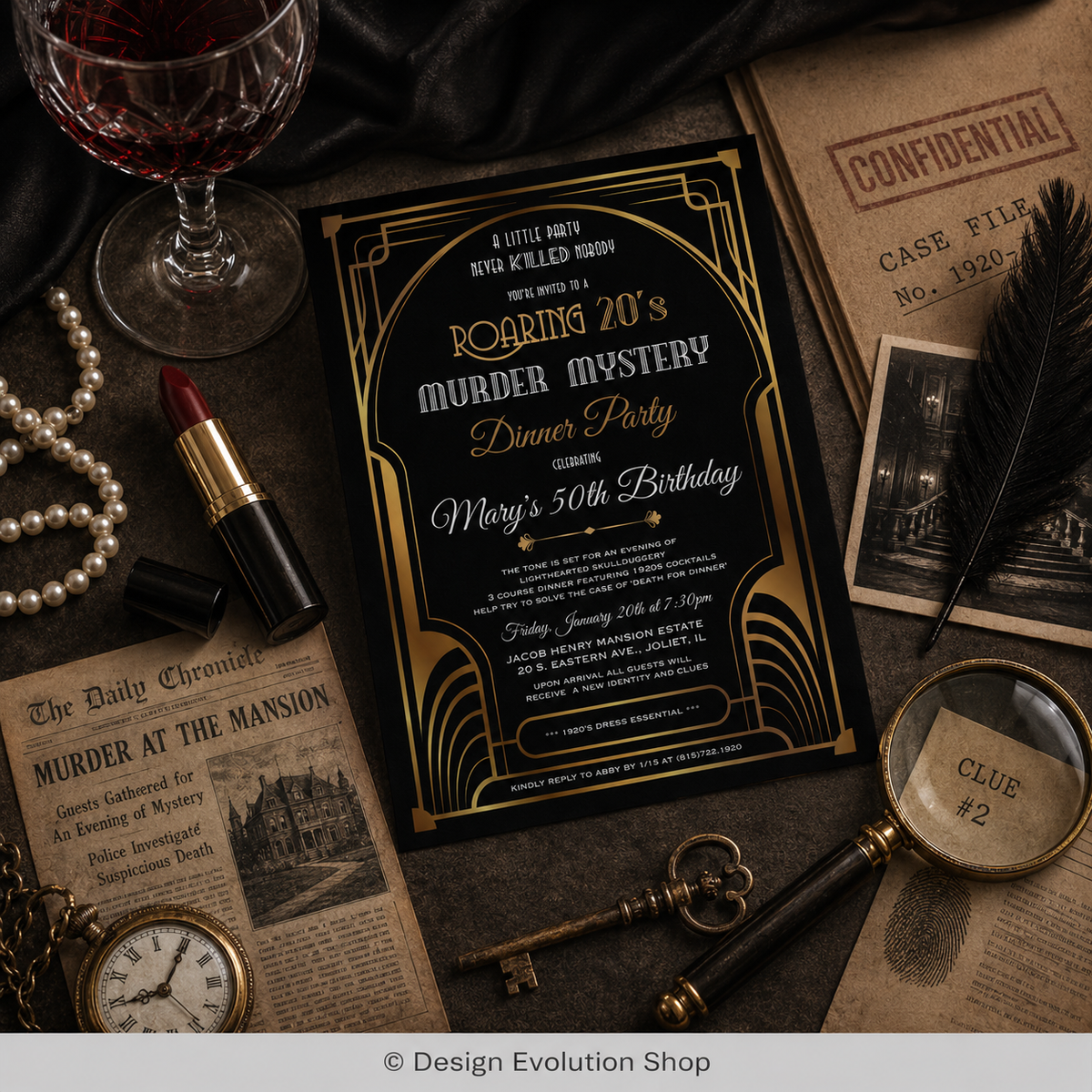 A styled flat-lay of a gothic art deco birthday invitation card, surrounded by vintage props including a glass of red wine, pearls, lipstick, a key, a magnifying glass, and old newspapers on a dark fabric background.